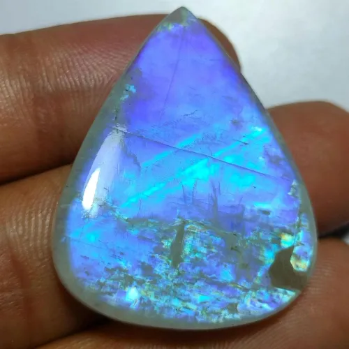 Comparison of natural moonstones under light showing adularescence effect